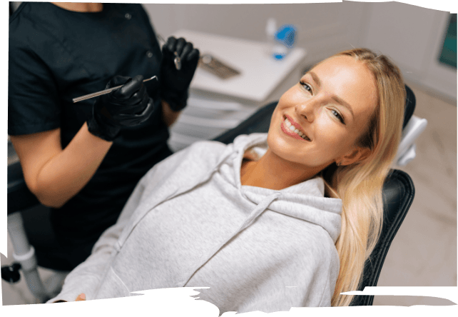 Smiling blonde woman leaning back in dental chair