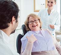 Woman smiling while asking dentist in Worcester questions about root canal therapy