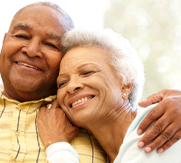 older couple smiling with dental implants in Worcester