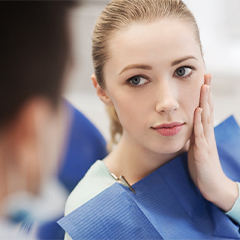 Patient learning about gum disease from her Worcester dentist